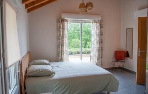 a bedroom with a large bed and a window at Gîte du Causse Loubressac in Loubressac +35 photos