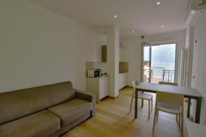 a living room with a couch and a table at Casa Manu in Brenzone sul Garda