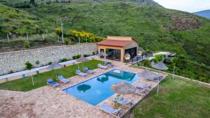 an aerial view of a house with a swimming pool at Dreamy Farm in Sarandë