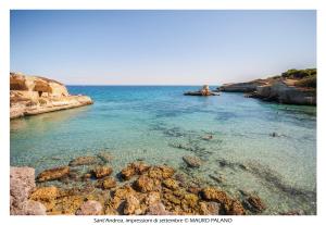 a view of a body of water with rocks at Agriturismo Tenuta Kyrios con piscina in Borgagne