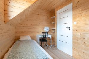 a bedroom with a bed and a desk in a attic at Siedlisko Jantar Resort&Spa in Jantar +38 photos