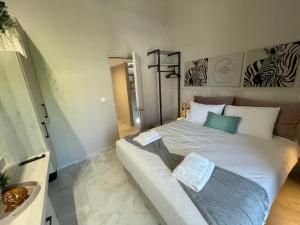 a bedroom with a large white bed with two pillows at Kelevi Seaside Apartment in Nikiti