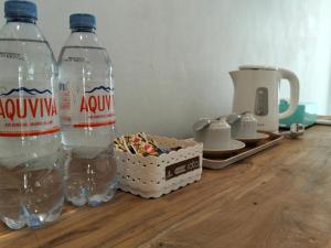two bottles of water sitting on a wooden table at Ijen Cottages in Jambu
