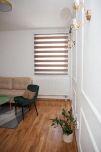 a living room with a couch and a chair at Apartman N Pale in Pale