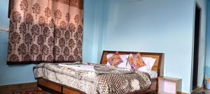 a bedroom with a bed with a cheetah patterned curtain at BV Homestay Kalpa By Soma Stays in Chini