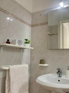 a white bathroom with a sink and a mirror at Il Fico d'India - Home Salento com in Ugento +27 photos
