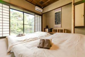 Postel nebo postele na pokoji v ubytování 逸仙居 Japanese Style House