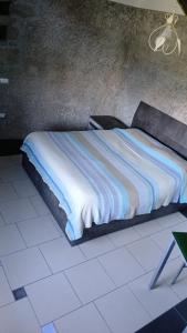 a bed in a room with a white floor at La Torre in Vitorchiano