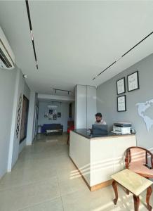a man sitting at a counter with a laptop at Premium Studio Apartment # 212 Near Bombay Hospital in Siroli +34 photos