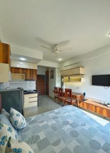 a large kitchen with a large bed in a room at Premium Studio Apartment # 212 Near Bombay Hospital in Siroli