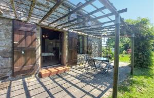 a pergola over a patio of a house at Maison À La Campagne in Le Ferré +9 photos