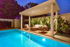 a house with a swimming pool and a patio at 4BR Luxury Pool Villa in Chiang Mai - Family-Friendly in Chiang Mai