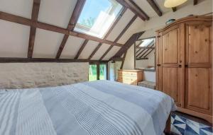 a bedroom with a large bed and a window at Maison À La Campagne in Le Ferré