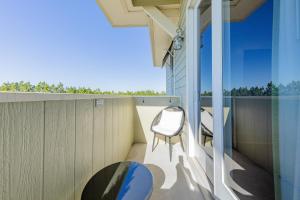 d'un balcon avec une chaise et une table. dans l'établissement 30A Modern Suite with King Bed, Parking, Pool and Balcony, à Santa Rosa Beach