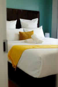 a large bed with white sheets and pillows at Stunning 1 bed in Midrand at 93 On New Estate in Midrand