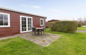 a patio with a table and chairs in a yard at 2 Bedroom Cozy Home In Wagenborgen in Wagenborgen +32 photos
