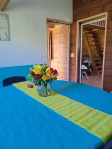 a vase of flowers on a table in a room at Le chal'heureux in La Plaine des Palmistes