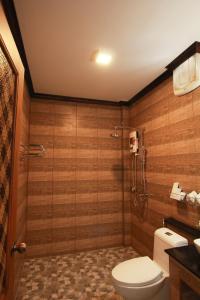 a bathroom with a toilet and a glass shower at Cabana Lipe Beach Resort in Ko Lipe