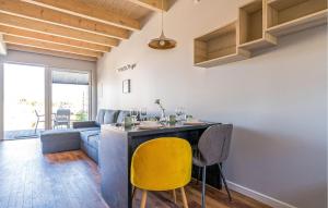 a living room with a blue couch and yellow chairs at Awesome Apartment In Nowecin With Sauna in Nowecin