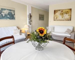 una sala de estar con una mesa con un girasol. en Beach, sun, air conditioning and parking in Agay!, en Saint-Raphaël
