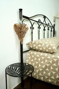 a bedroom with a bed with a chair next to it at B&B del Gatta in San Severo