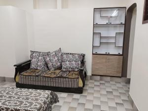 a bedroom with a bed and a dresser in a room at Jyothi homes in Tirupati