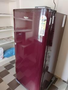 a purple refrigerator with a sticker on it at Jyothi homes in Tirupati