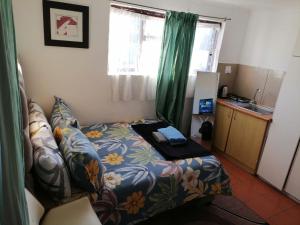 a small room with a bed and a kitchen at 72 Hamilton the trout lodge in Goodwood