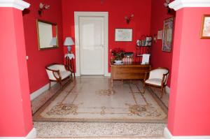 a red room with a white door and a red wall at Residenza Mosco in Tuglie