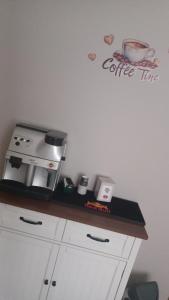 a counter with a coffee time sign on a wall at B&B home vintage in Marconia +18 photos