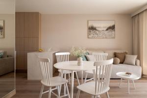 a living room with a table and chairs and a couch at Piwna Apartamenty nad morzem Władysławowo in Władysławowo +160 photos