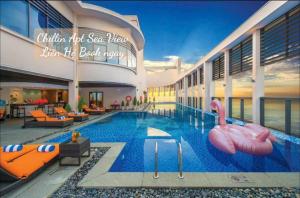 a swimming pool with inflatable flamingos in a building at Lux Chillin APT - Căn Hộ Hướng Biển Đà Nẵng in Danang