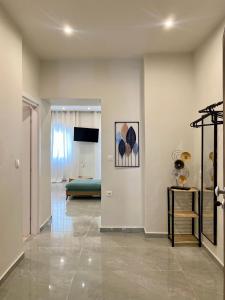 a hallway with a living room with a couch at Stone Luxury Suite in Galatás