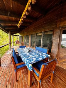 a dining table and chairs on a deck at Latui Lodge in Savusavu