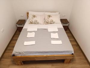 a bedroom with a large bed with white sheets and pillows at Kuca za odmor B in Kosor +26 photos