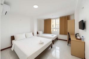 Postel nebo postele na pokoji v ubytování K&T Hotel - Bùi Viện Walking Street