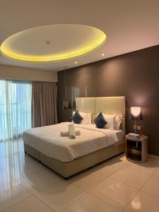 a bedroom with a large bed with a yellow ceiling at 4905 Luxury View By Royal Sky Vacation Homes Paramount Tower A in Dubai