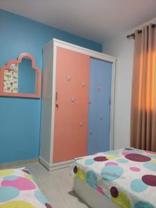 a bedroom with a bed and a large closet at شاليه مميز بقريه مارينا دلتا السياحيه olooool8369 in Al Ḩammād