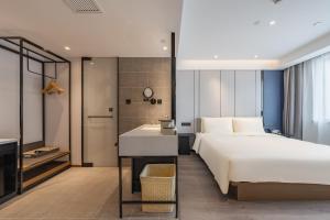 a hotel room with a bed and a bathroom at Atour Hotel Hangzhou West Lake Hubin North Zhongshan Road in Hangzhou +35 photos