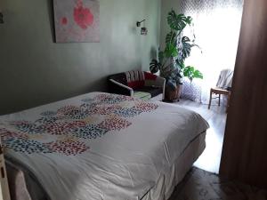 a bedroom with a bed and a chair and a window at Maison de Hameau in Breil-sur-Roya