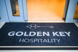 a door with a sign that reads golden key hospitality at Boutique Hotel Golden Key - Poreč - Bed & Breakfast in Poreč
