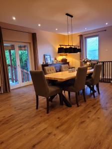 a dining room with a wooden table and chairs at Gárdonyi Ház in Sály