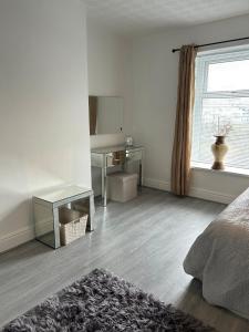 a white room with a bed and a window at Chapel house-M65- Hospital- parking-shops-food in Nelson