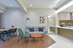 a living room with a couch and a table at Sunday Hotel Near Petronas Twin Tower Formerly Suasana Suites in Kuala Lumpur +147 photos