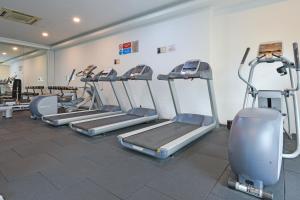 a gym with a row of treadmills and machines at Sunday Hotel Near Petronas Twin Tower Formerly Suasana Suites in Kuala Lumpur