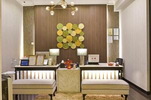 a hotel lobby with two beds and a desk at Sunday Hotel Near Petronas Twin Tower Formerly Suasana Suites in Kuala Lumpur
