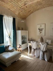 a living room with a couch and a table and chairs at Charm & comfort in Nettuno