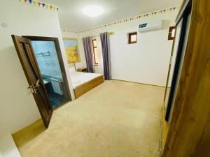 a room with a door open to a bedroom at Afsona guest house in Bukhara