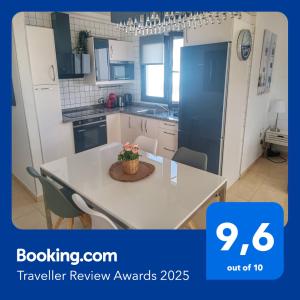 a kitchen with a table with a potted plant on it at CASA CUADERNA a 150 metros de la playa in Playa Honda