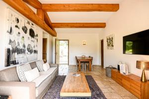 a living room with a couch and a table at Auberge de l'Oumède in Saint-Tropez